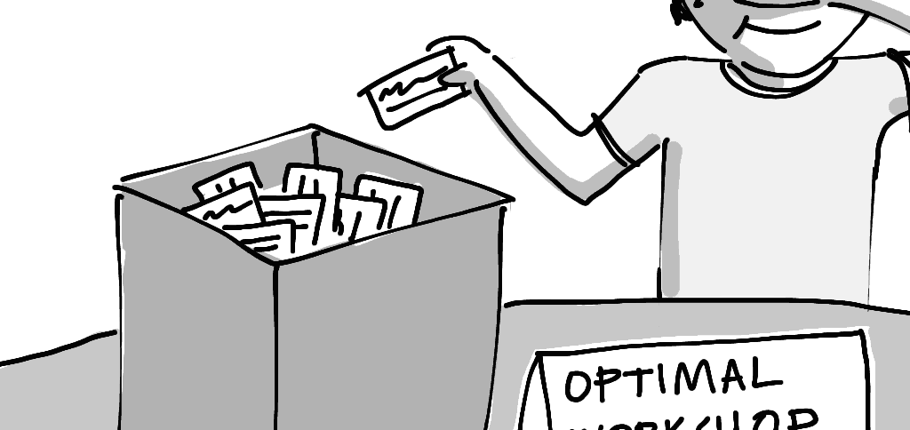 A man reaches into a box to select a card with the winner's name on it