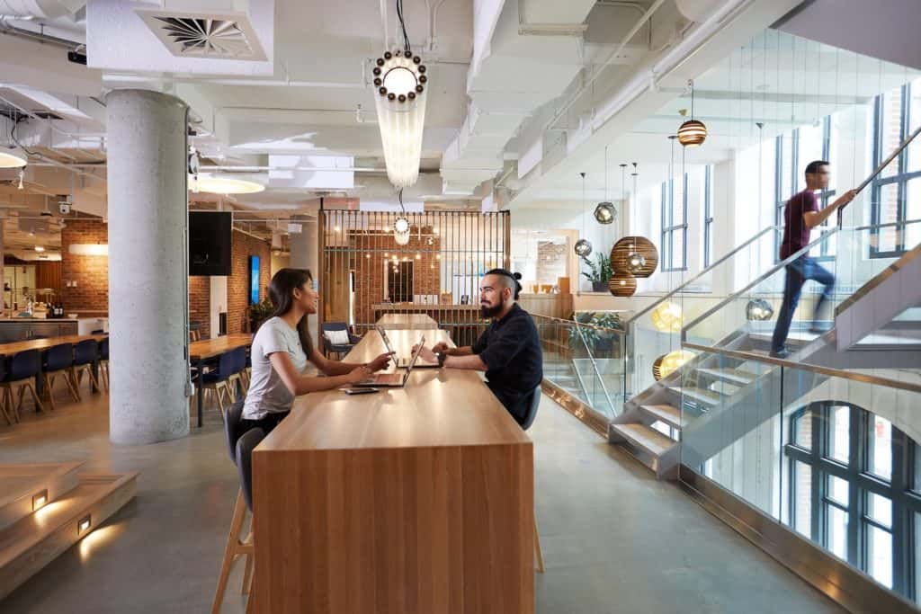 Two people sitting in a common area in Shopify’s office