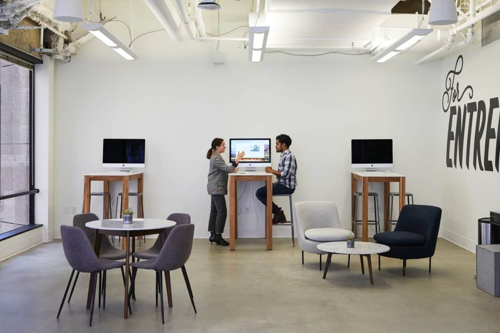 Two people working together in a room in Shopify’s office